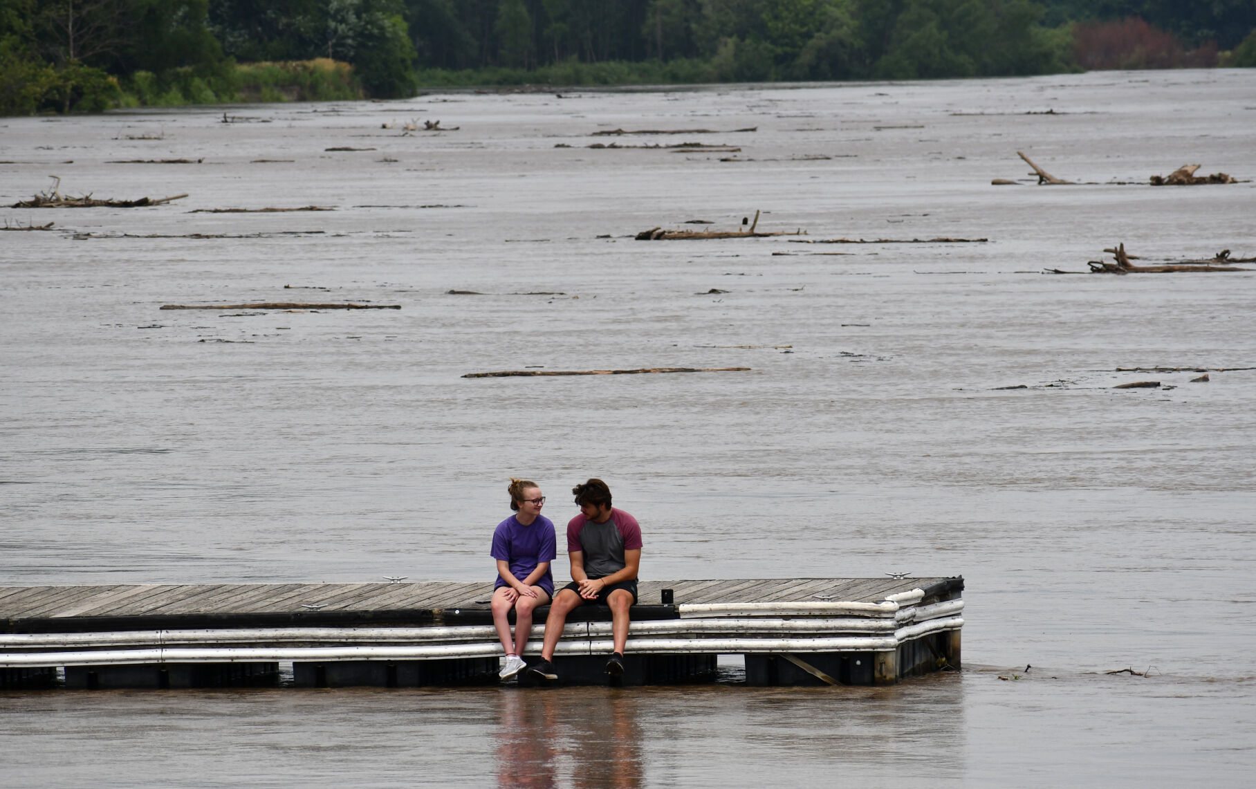 Cassie Meyers and Nathan Noland sit on a dock
